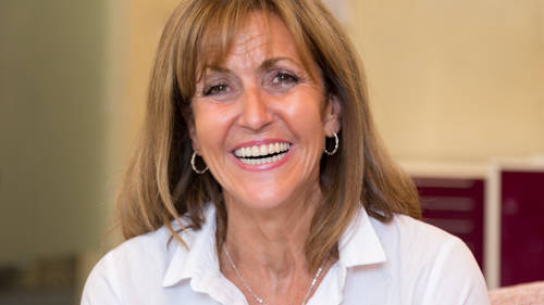Susan (holding Image) (1 of 1) 19 Portrait of smiling female patient reflecting successful implant treatment